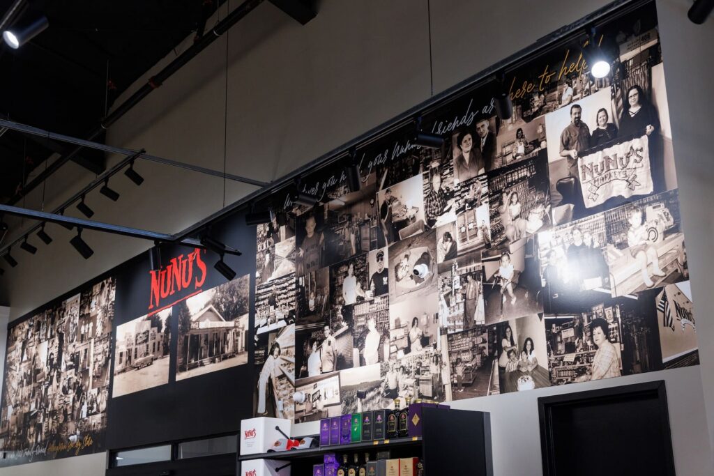A collage of vintage black-and-white photos and a “NuNu’s” sign decorates a high wall above shelves in the store.