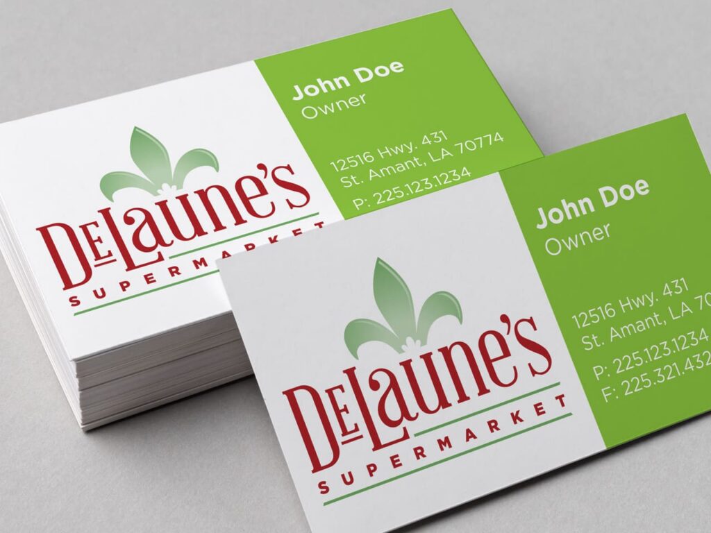 A stack of DeLaune’s Supermarket business cards featuring owner John Doe’s contact info on a green and white background.