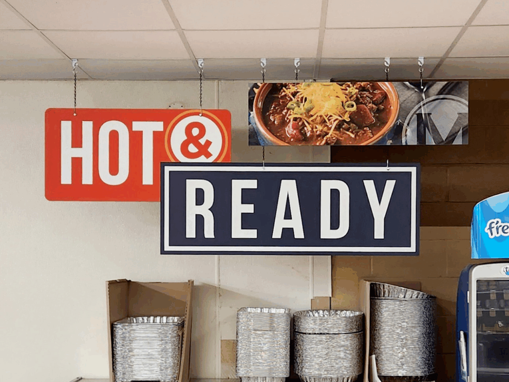 Two hanging signs read 